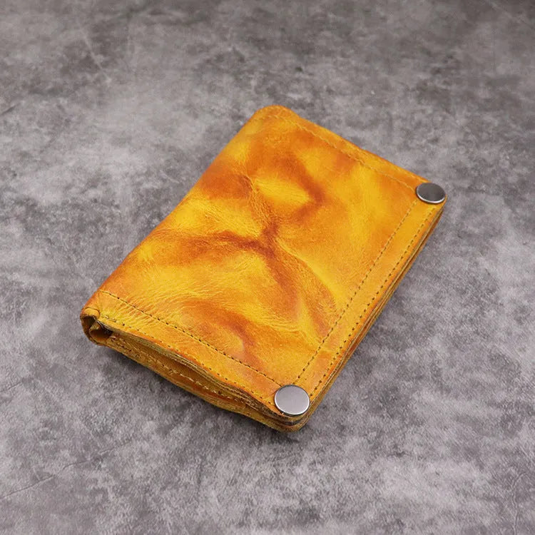Men's brown leather bifold wallet open showing multiple card slots and coin pocket
