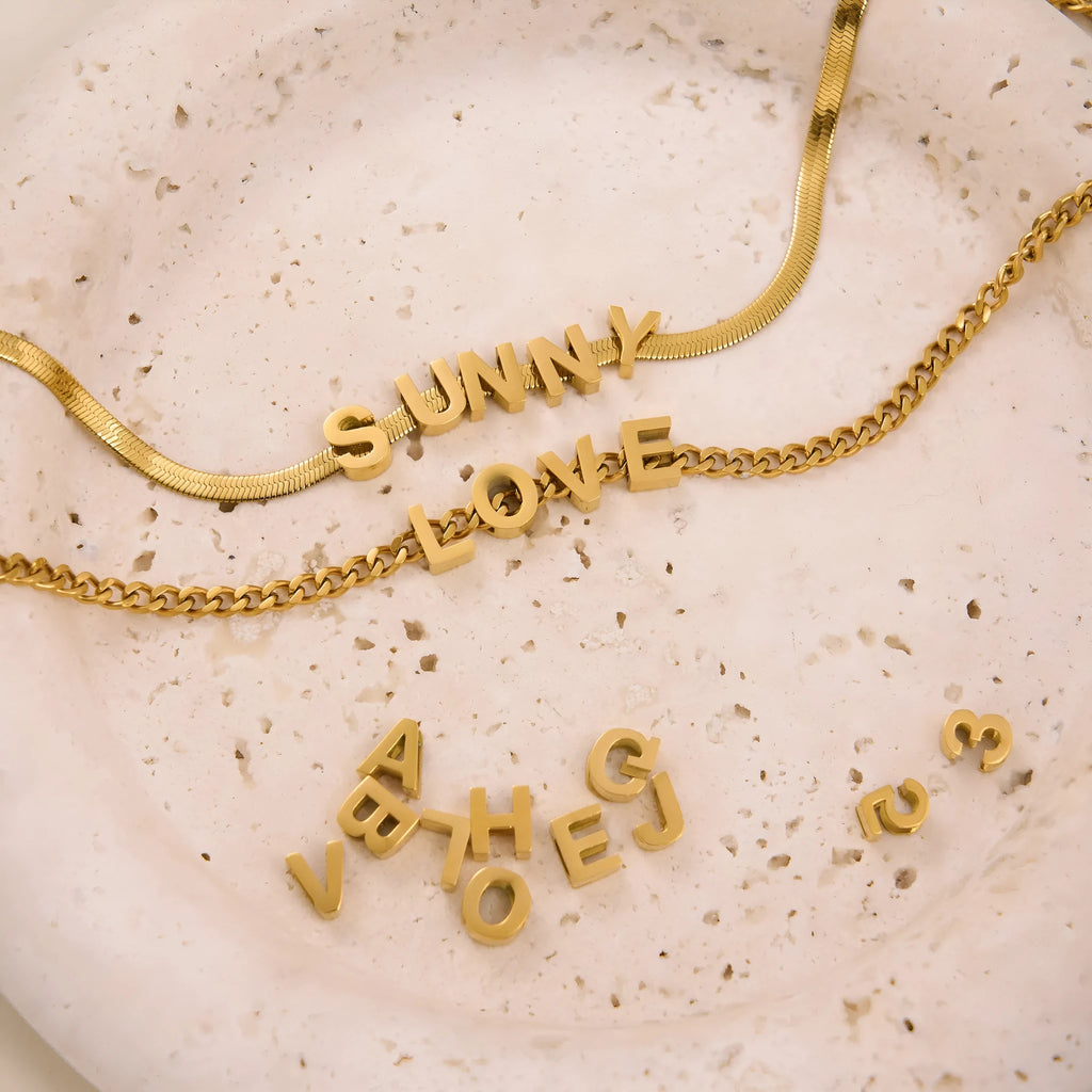 Personalised titanium steel necklace with a single letter A charm on a 40 cm gold chain.