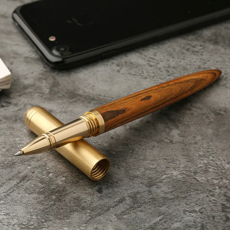 Brass and solid wood signature pen showing wood grain and metal components