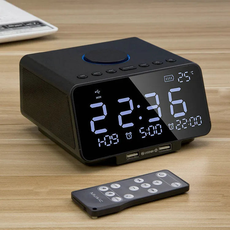 Black and white wireless Bluetooth alarm clock speaker with digital display, showing radio and call functions.