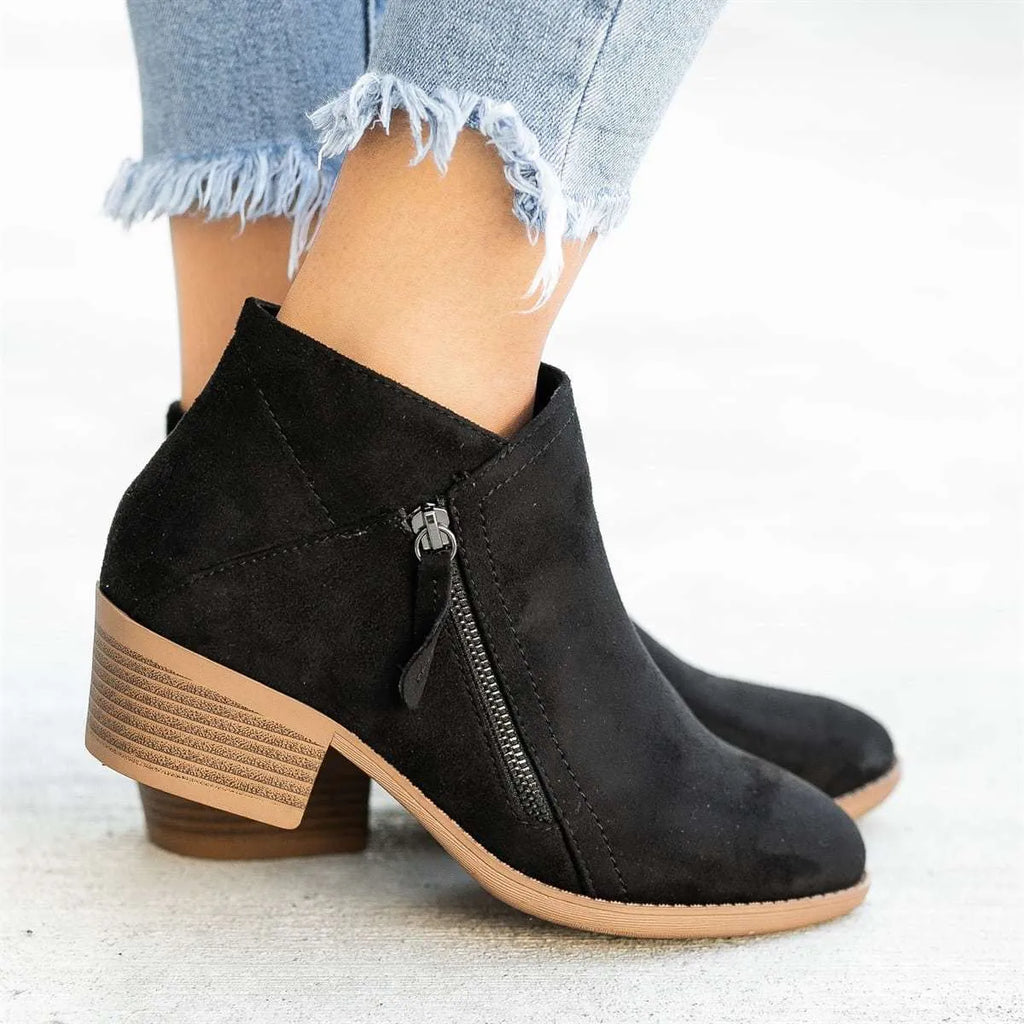 Women's beige suede ankle boot with side zip, lace-up front, and chunky composite sole.