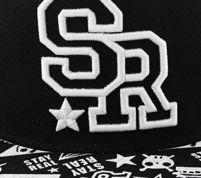 Cotton baseball cap with embroidered letters in black or white, showing adjustable strap and dome crown.