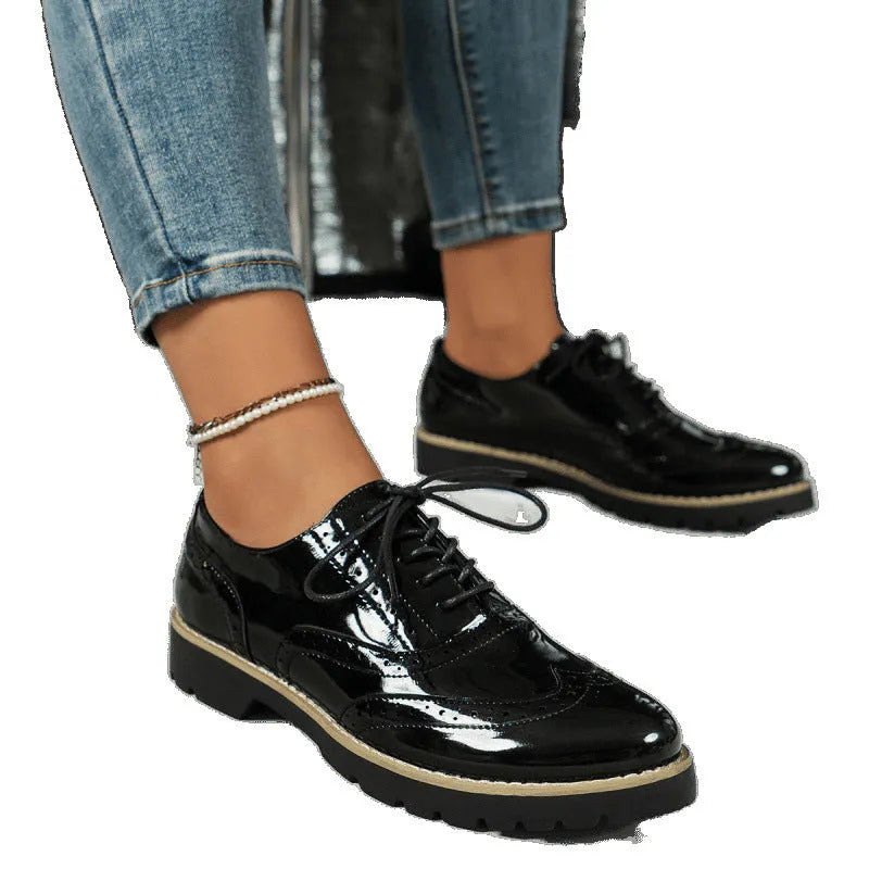 Women's black lace-up loafers with wedge heel and sequin details on the upper.