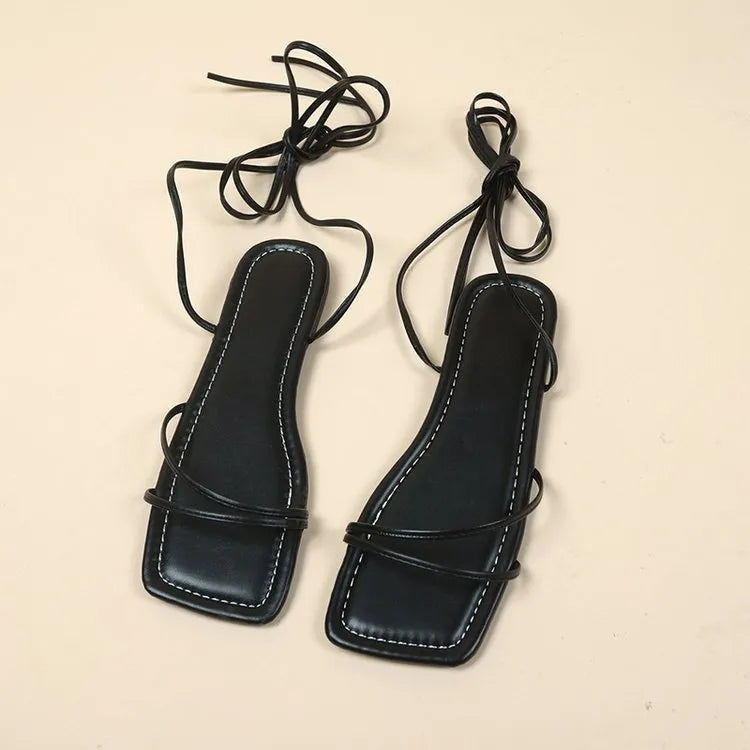 Women's flat sandals with ankle ring bandage detail and front lace-up closure in three colour options