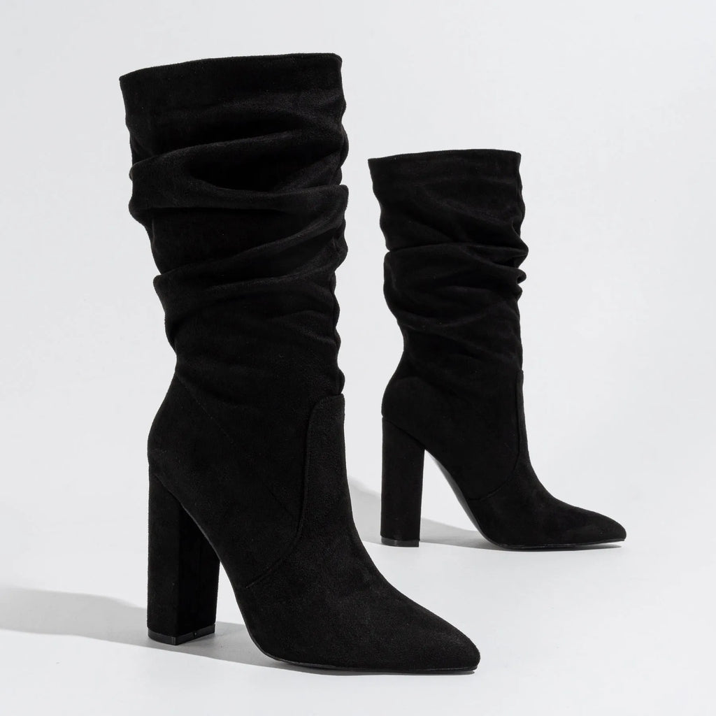 Women's black suede pointed-toe boots with a chunky high heel and mid-calf length