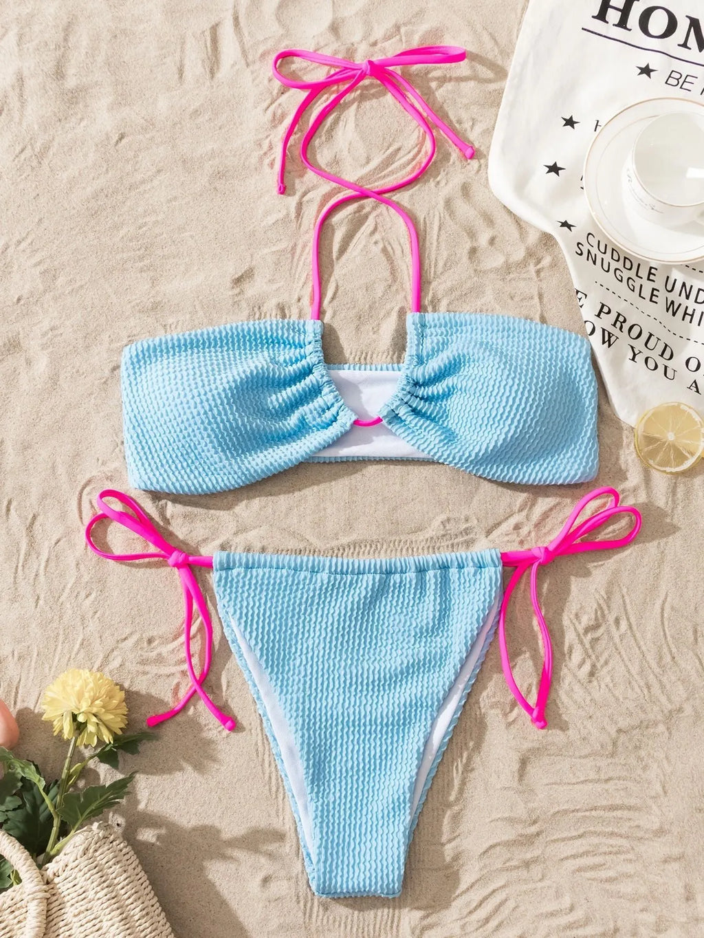 Solid colour women's two-piece swimsuit with halter lace-up top and briefs on a model