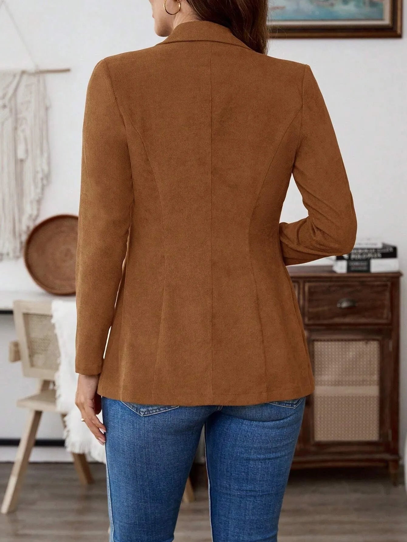 Brown men's single-breasted casual suit coat with long sleeves on a hanger