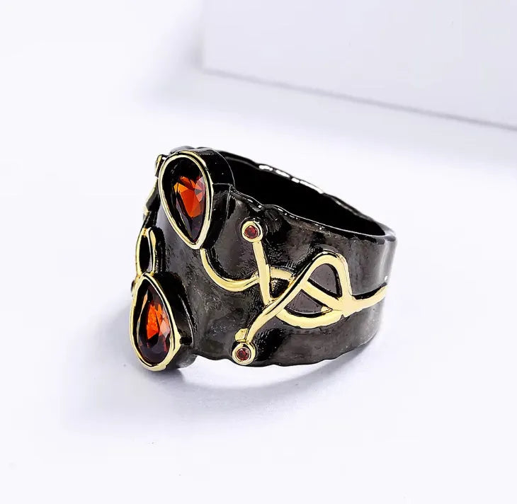 Retro women's brass oval ring in black finish on white background
