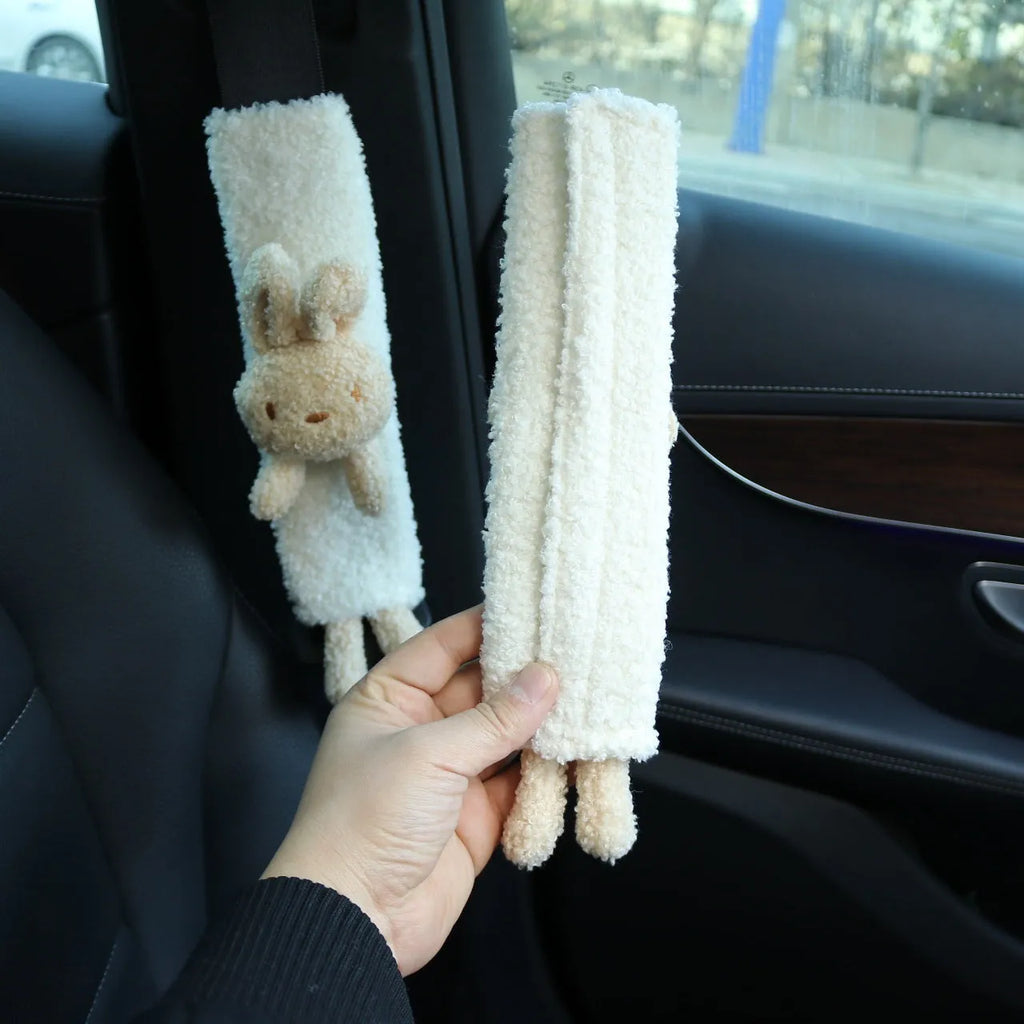 Cartoon plush car seat belt shoulder protector in lamb wool, showing rabbit and bear designs.
