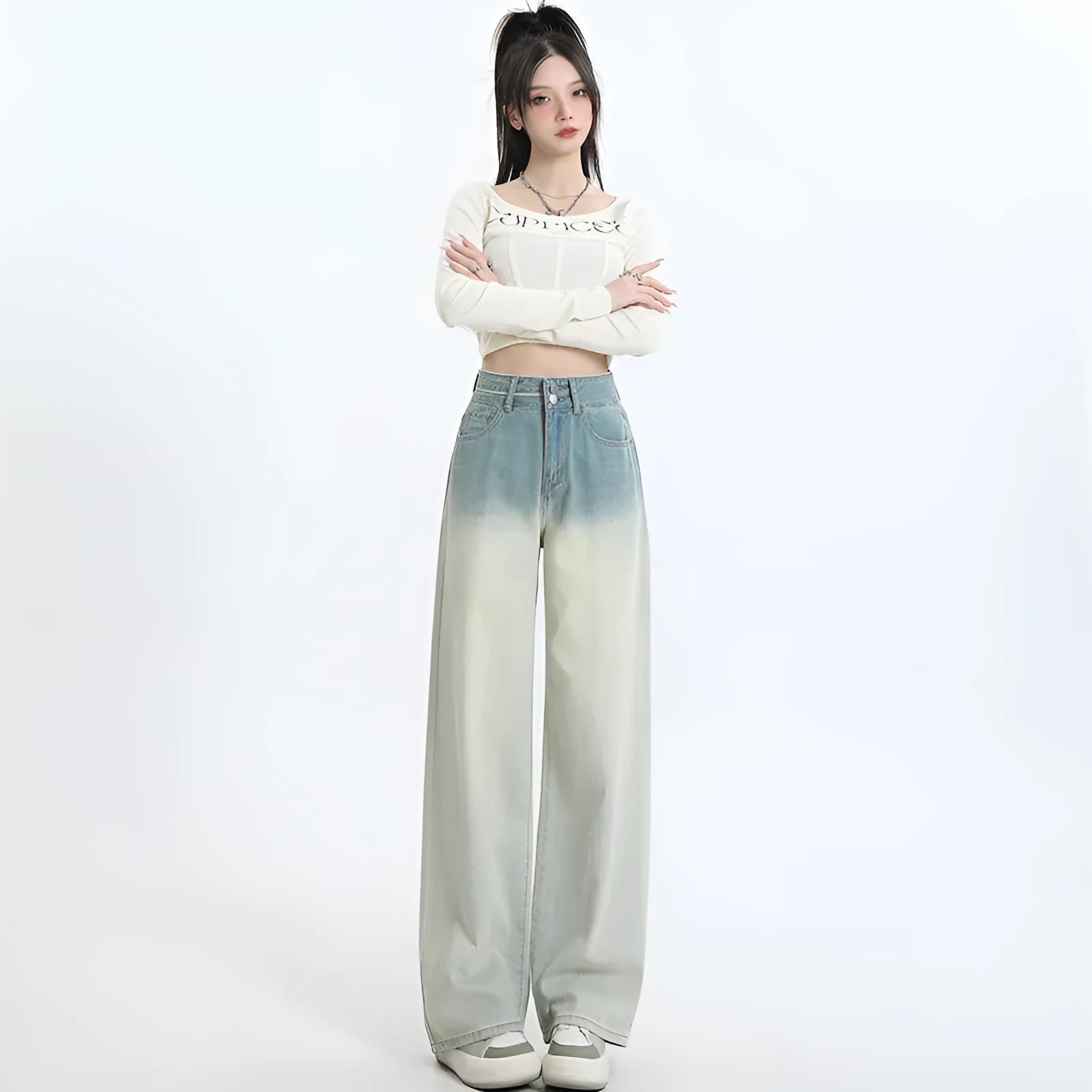 Gradient blue women's straight-leg denim trousers on a hanger, showing colour transition.