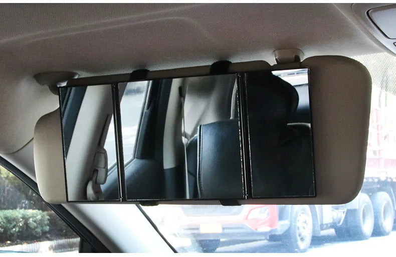 Silver portable car folding mirror shown both closed and opened on a flat surface.