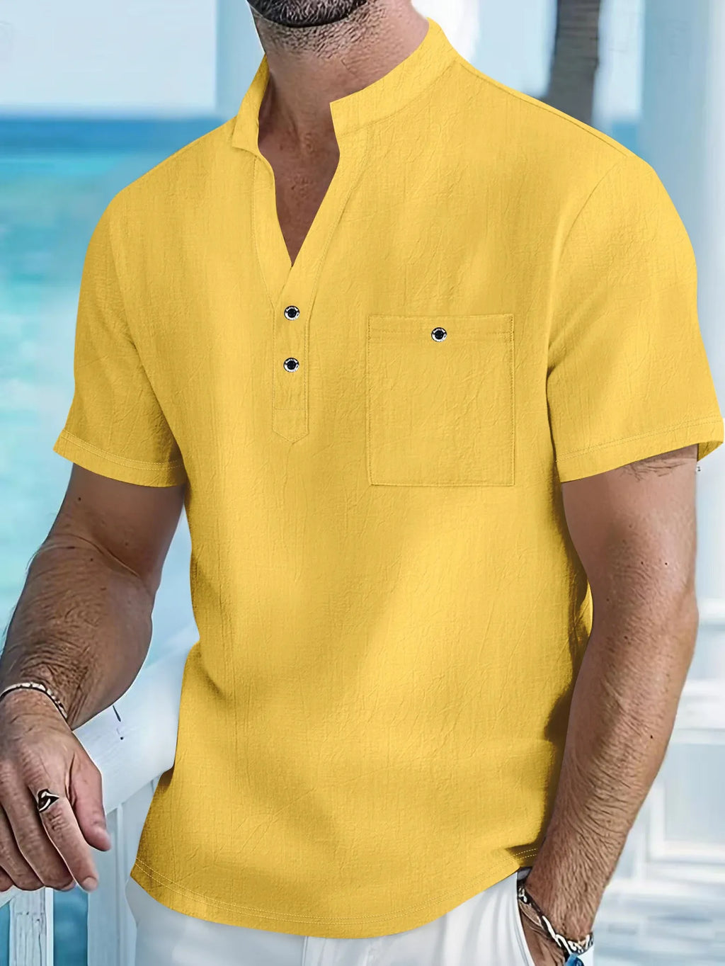 Man wearing a light apricot-coloured linen stand collar short sleeve shirt with a loose fit.