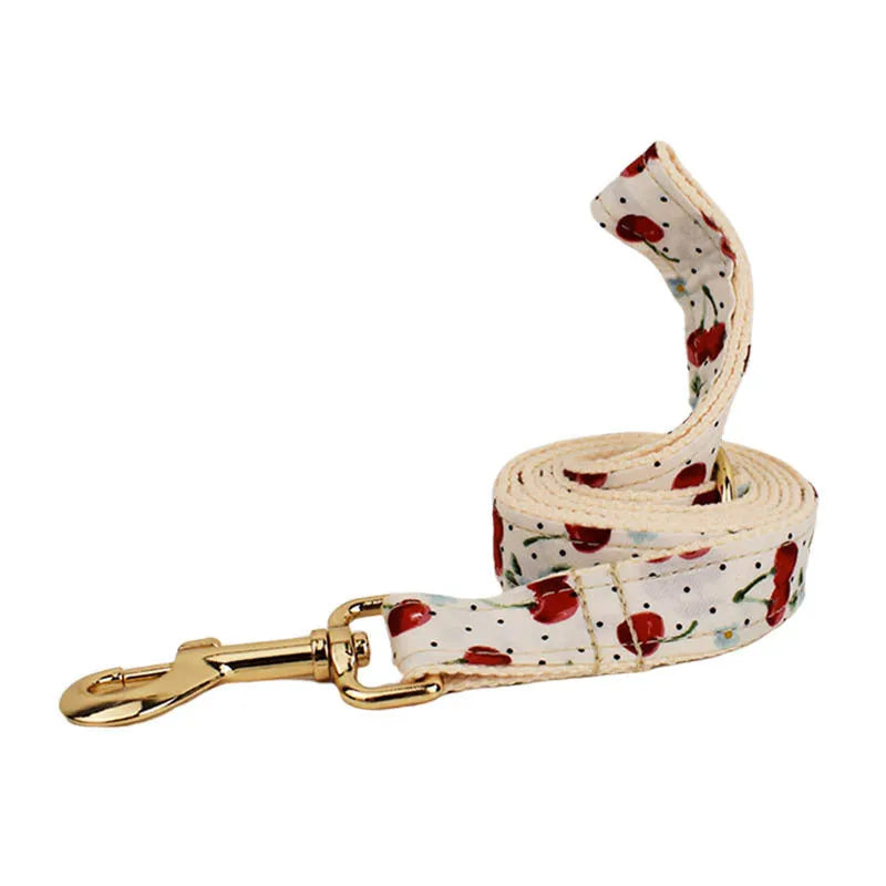Red cherry printed dog collar and leash set with light gold buckle and decorative bow strap