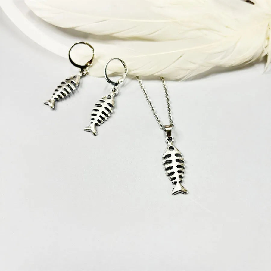 Women's vintage fishbone pendant necklace and matching earrings set with adjustable chain.