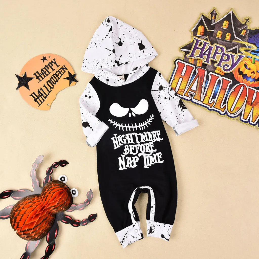 Black or brown cotton Halloween romper with long sleeves and a hood, laid flat.