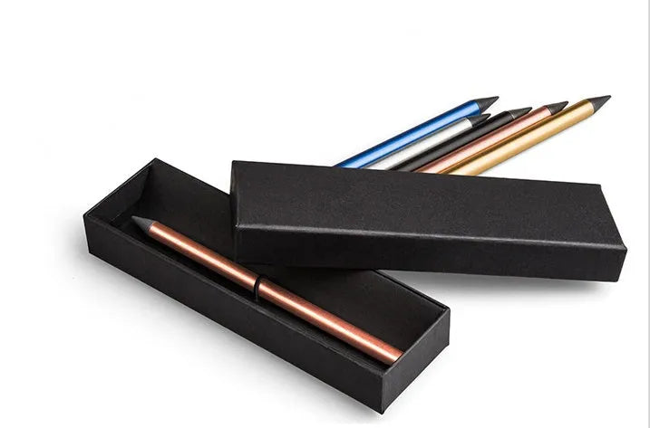 Silver inkless metal pen with alloy nib next to its storage box and spare nib.