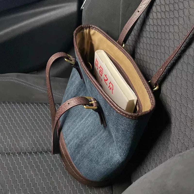 Denim patchwork bucket handbag with one shoulder strap showing retro styling