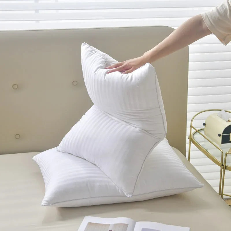 White cotton satin stripe feather pillow showing simple design and hotel-style aesthetic
