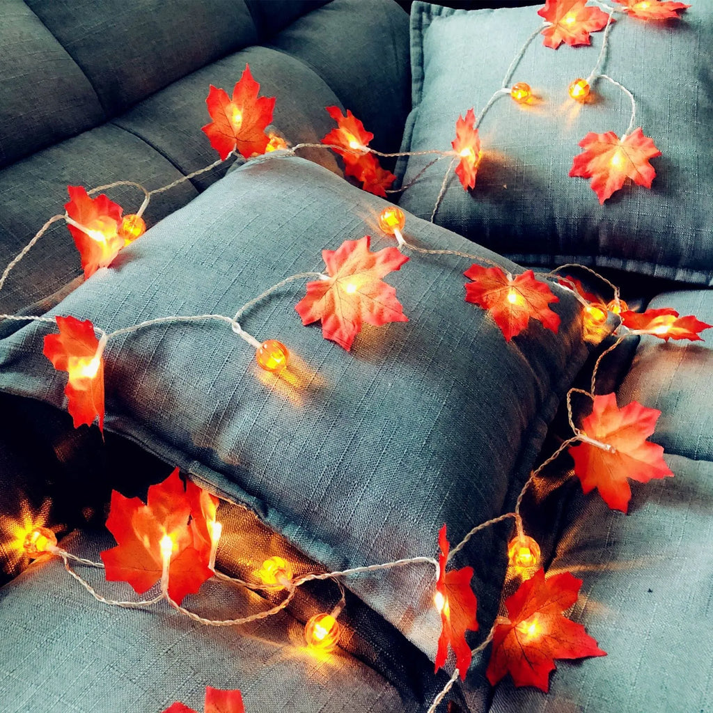 Halloween pumpkin and maple leaf LED light string on a dark background, with warm white 3000K glow