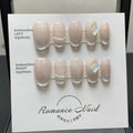 Women's false nails set with blush armour design in pink tones, short ladder tip shape