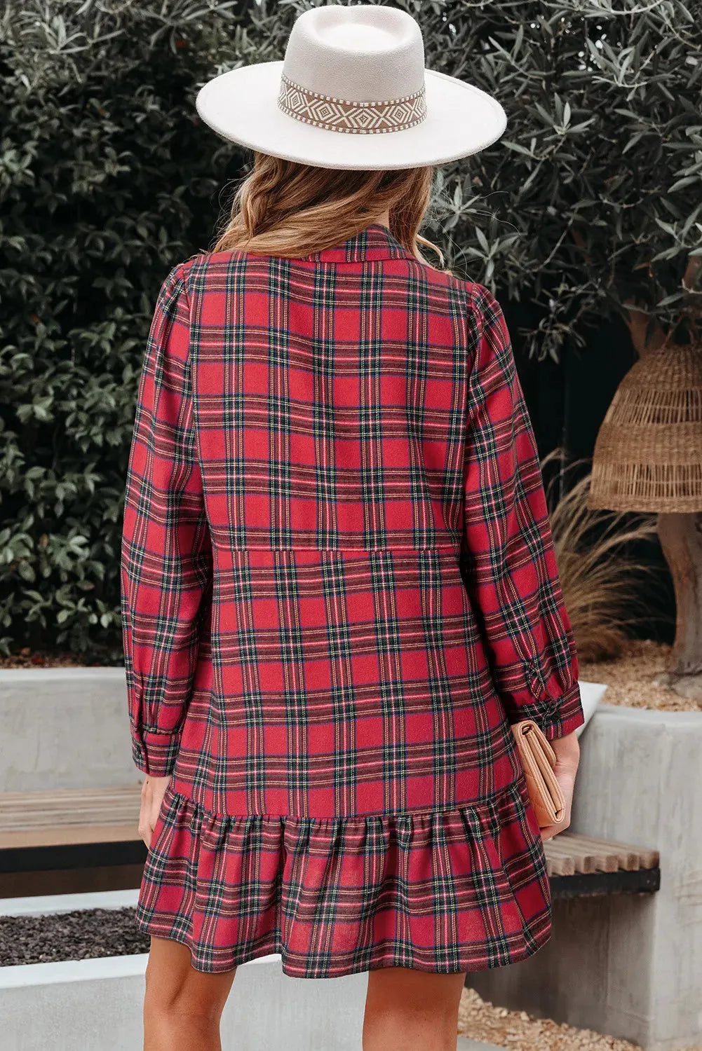 Red plaid mini dress with shirt collar, button front, long sleeves, and ruffle hem detail