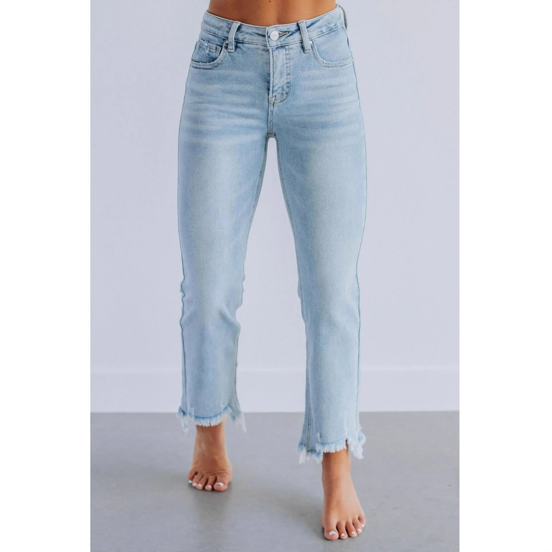 Women's dark blue denim casual trousers with a hand-distressed finish on a hanger.