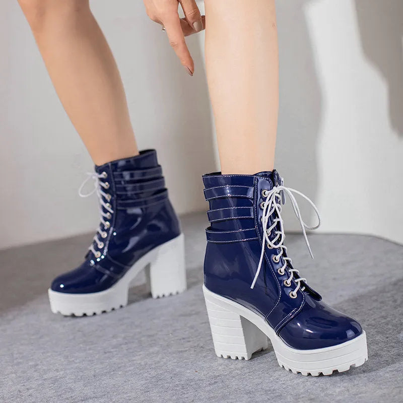 Women's black thick-heeled ankle boots with lace-up front and round toe on a waterproof platform