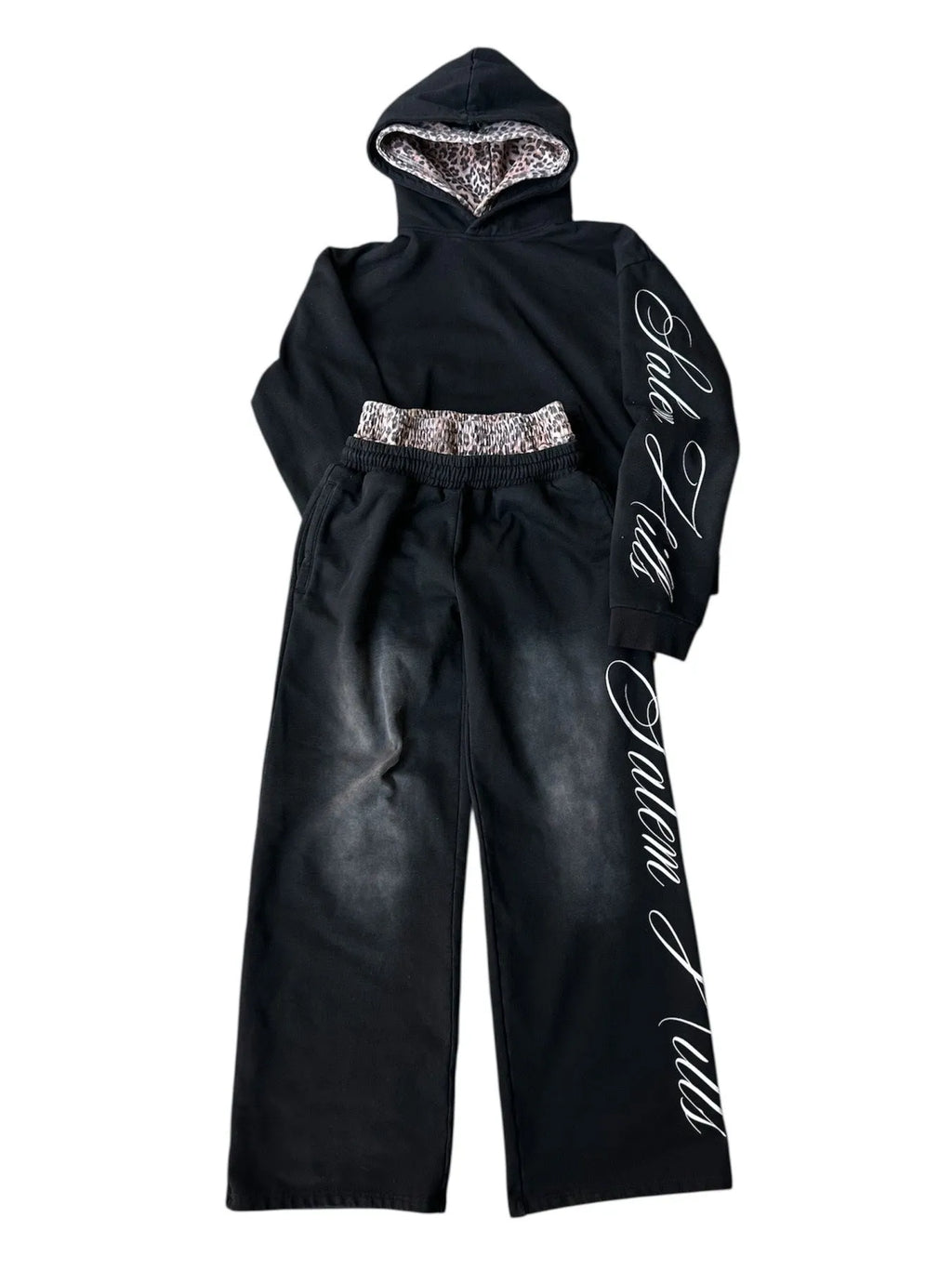 Men's black and white punk print pullover hoodie and pants tracksuit set on a hanger.