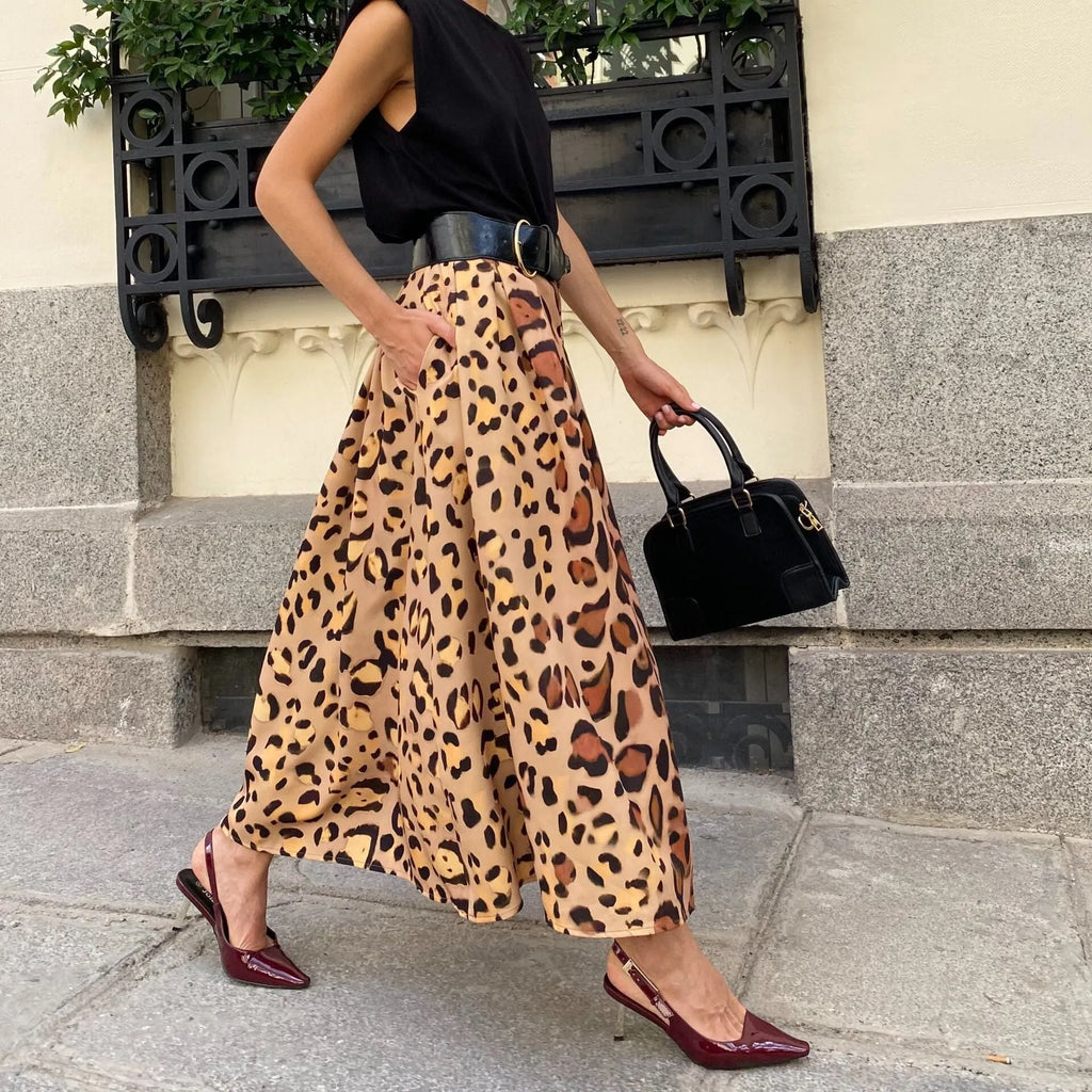 Women's long brown leopard print A-line skirt with a big hem.