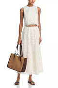 White women's sleeveless top and long skirt suit set with retro embroidery detail