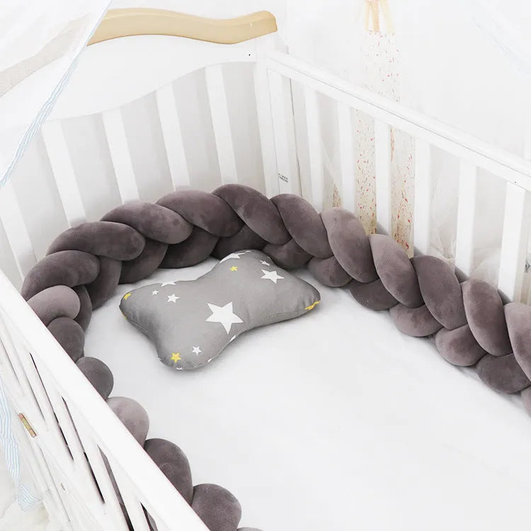 Baby crib bumper protector in spandex velvet, bent to show flexible shape, against a crib rail.