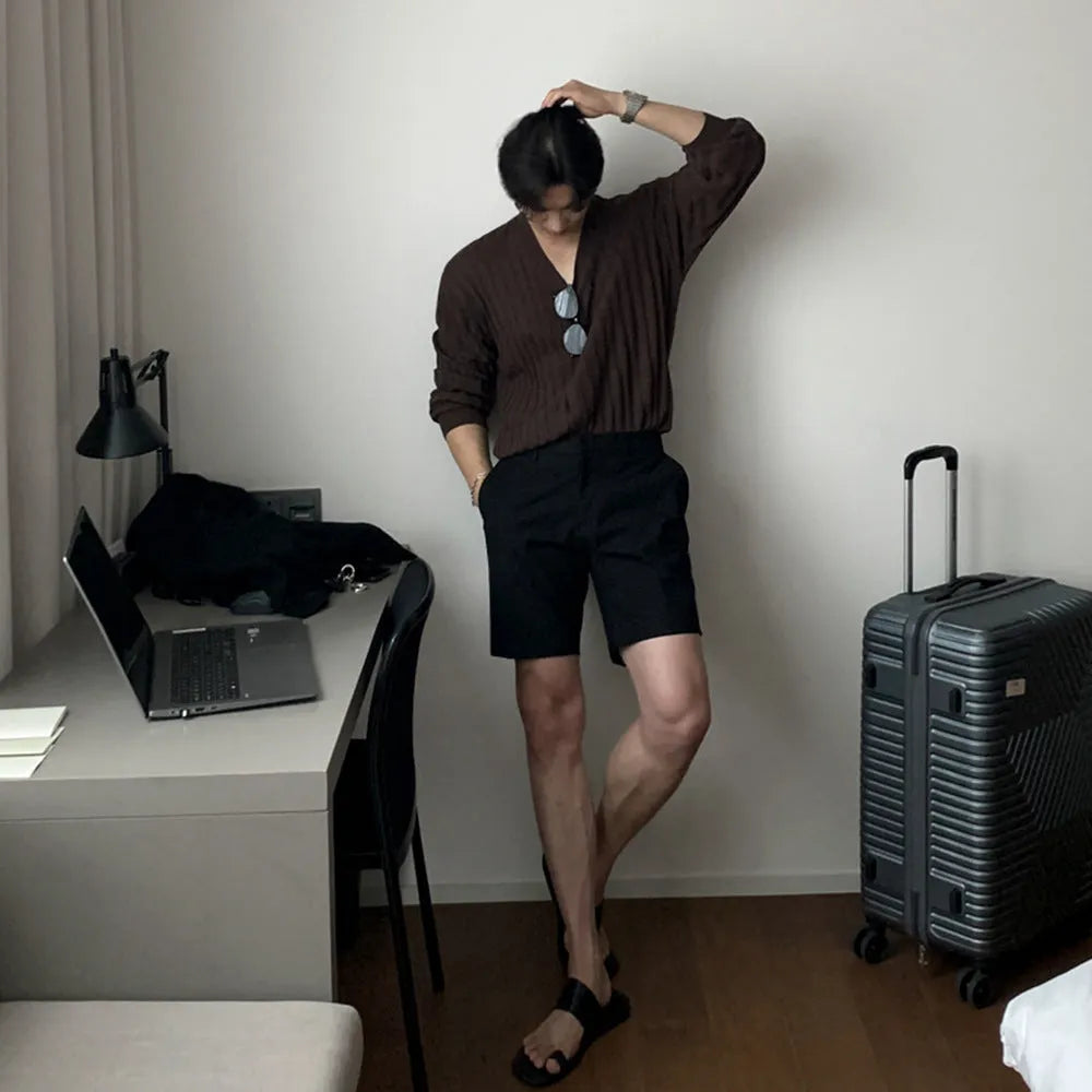 Men's straight-leg casual shorts in solid black colour, laid flat to show loose fit.