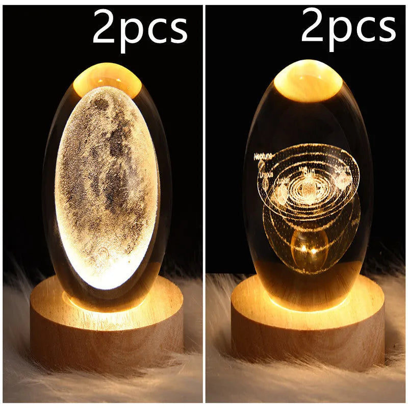 LED galaxy crystal ball night light with 3D planet designs on a table
