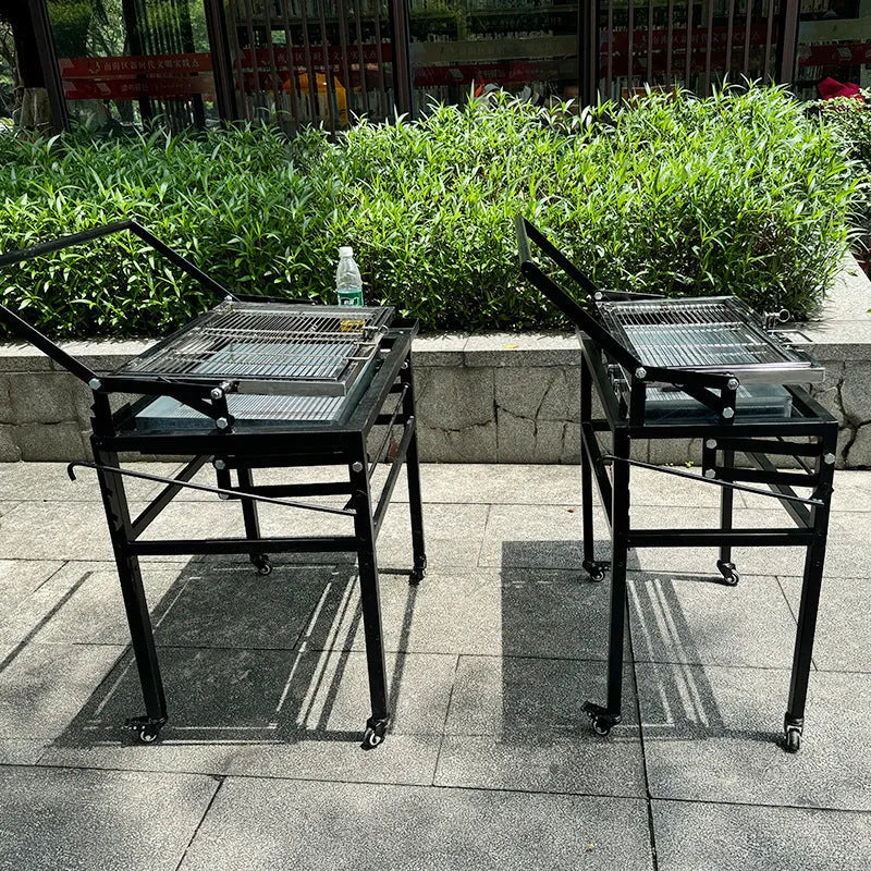 Large foldable charcoal BBQ stove with grill, shown in an outdoor setting.