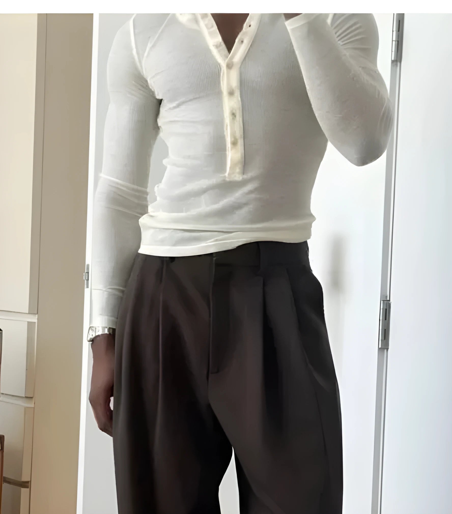 Cream-coloured men's ribbed long-sleeve Henley top with a buttoned placket.