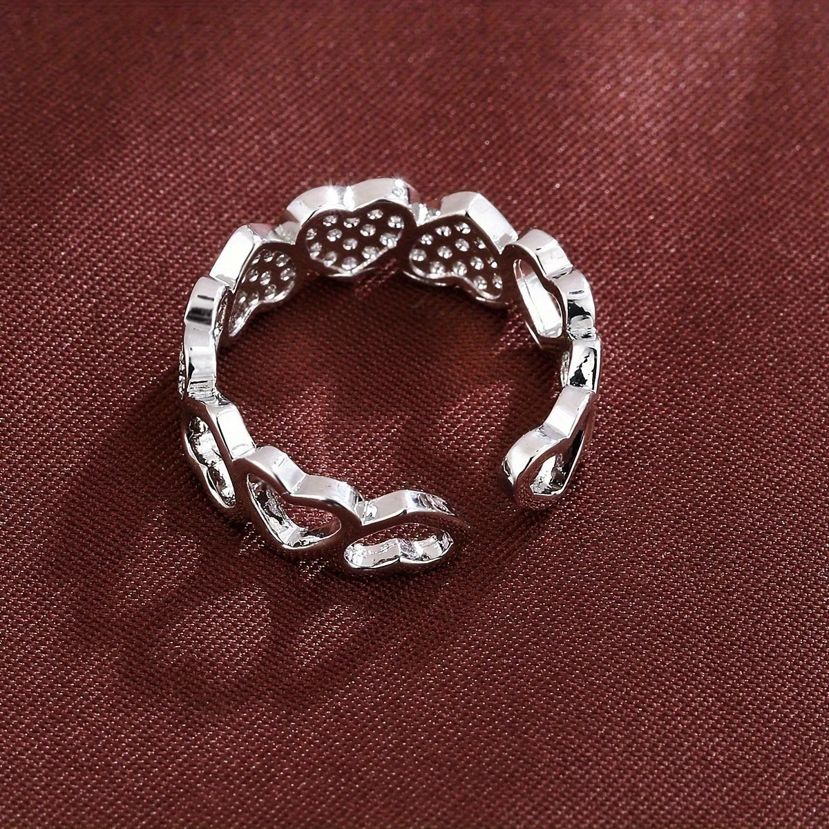 Adjustable gold and silver couples ring with love heart design on a geometry band.