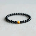 Black obsidian geometric bead bracelet in Korean style, showing size options.