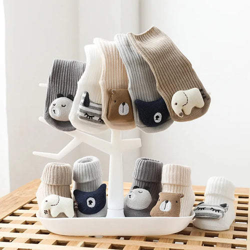 Baby socks with anti-slip glue dots on soles in combed cotton, showing mid-tube height and various colour options