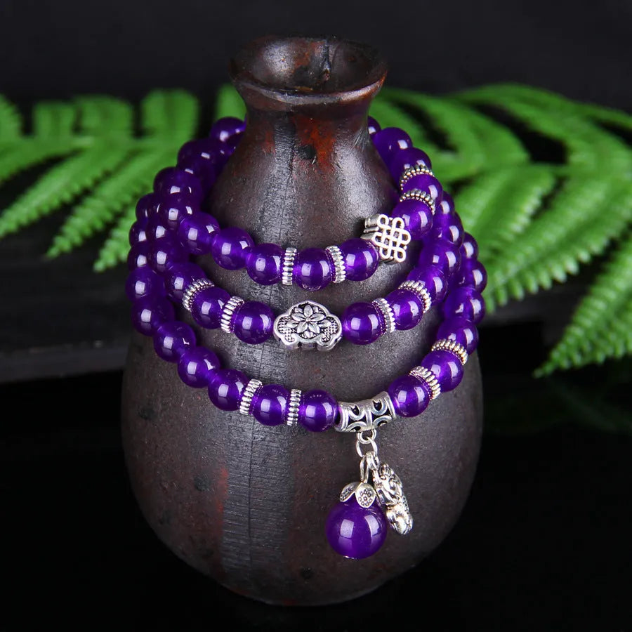 Purple ethnic-style women's bracelet with three circles of polished chalcedony beads on an adjustable band.