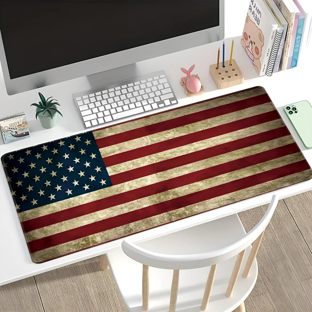Large desk pad with printed pattern on a wooden desk, showing non-slip rubber base.