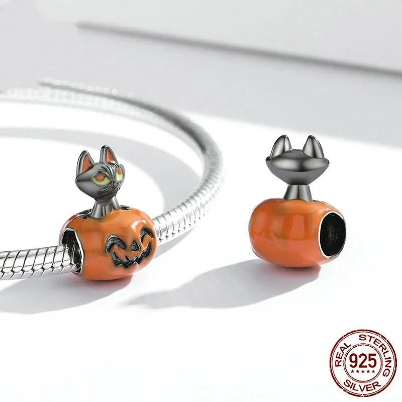 Close-up of sterling silver pumpkin black cat pendant with black gold plated oil dripping finish