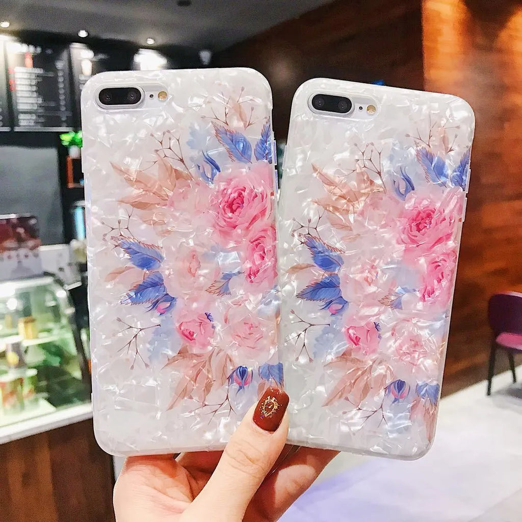 Dream Shell soft TPU iPhone case with rose flower design in brown, shown on an iPhone.