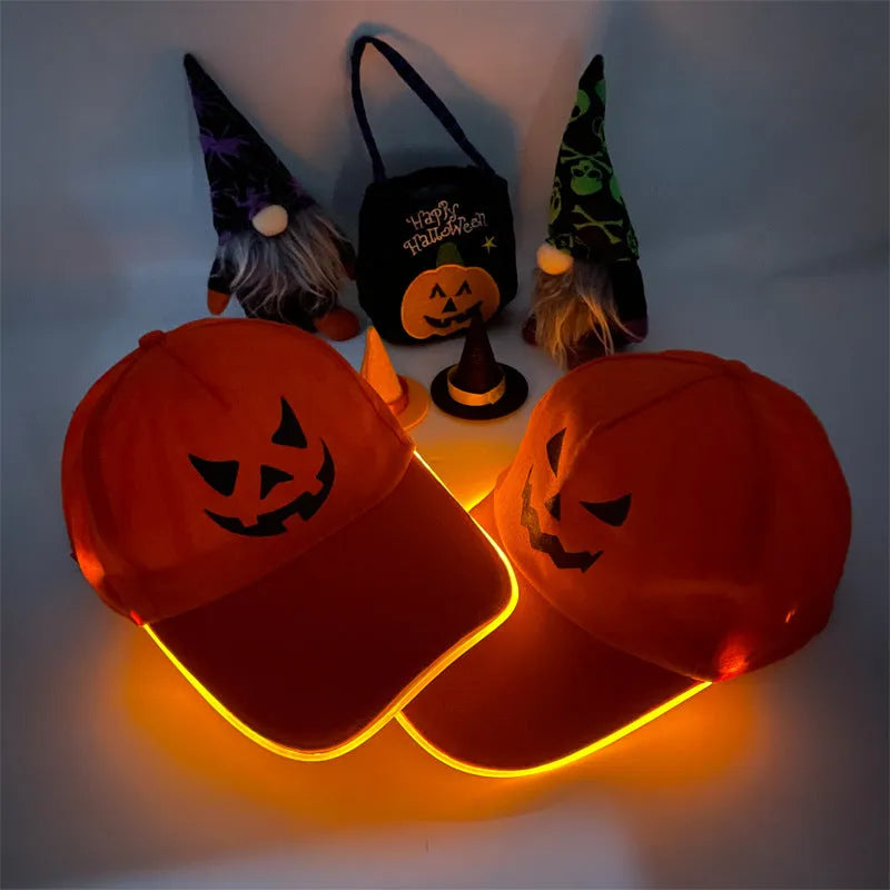 Black Halloween baseball cap with LED pumpkin smile face and yellow lights illuminated.