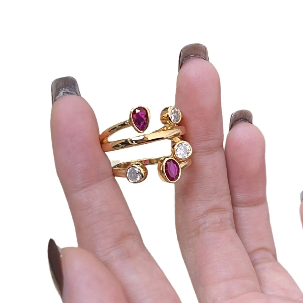 Geometric retro-style ring with an irregular cross design set with diamonds, in two-tone colours.