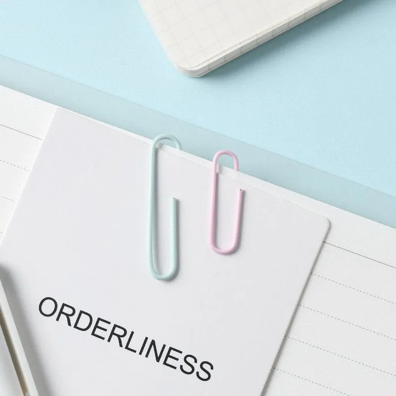 Set of macaron colour alloy paper clips in pink, green, and purple, showing 28mm and 50mm sizes, on a light background