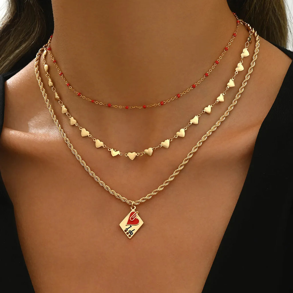 Three-layer geometric heart pendant on an adjustable zinc alloy clavicle necklace.