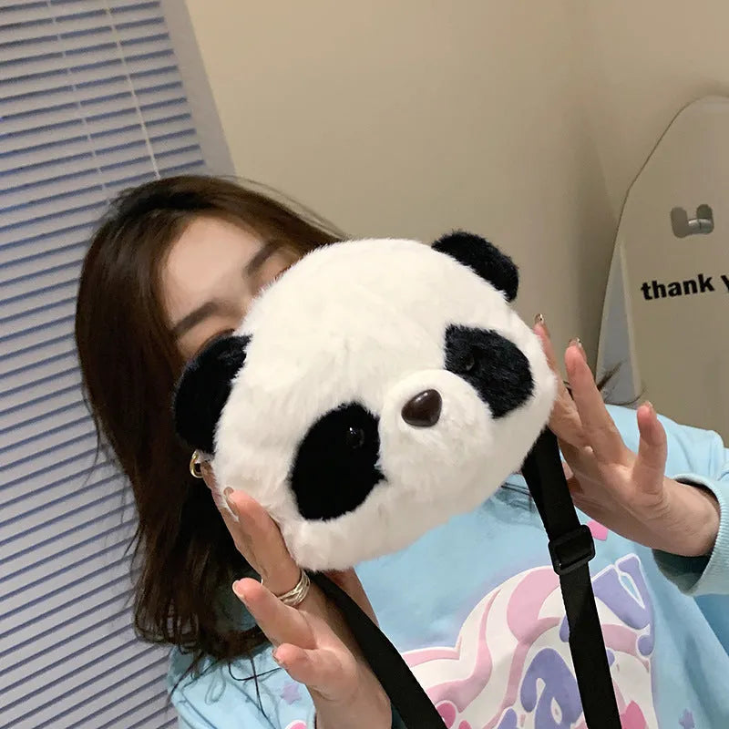 Soft plush crossbody bag with panda head design, shown in cylindrical shape.