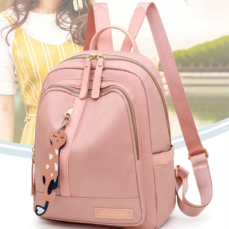 Black and pink women's casual nylon backpack showing soft surface and shoulder straps
