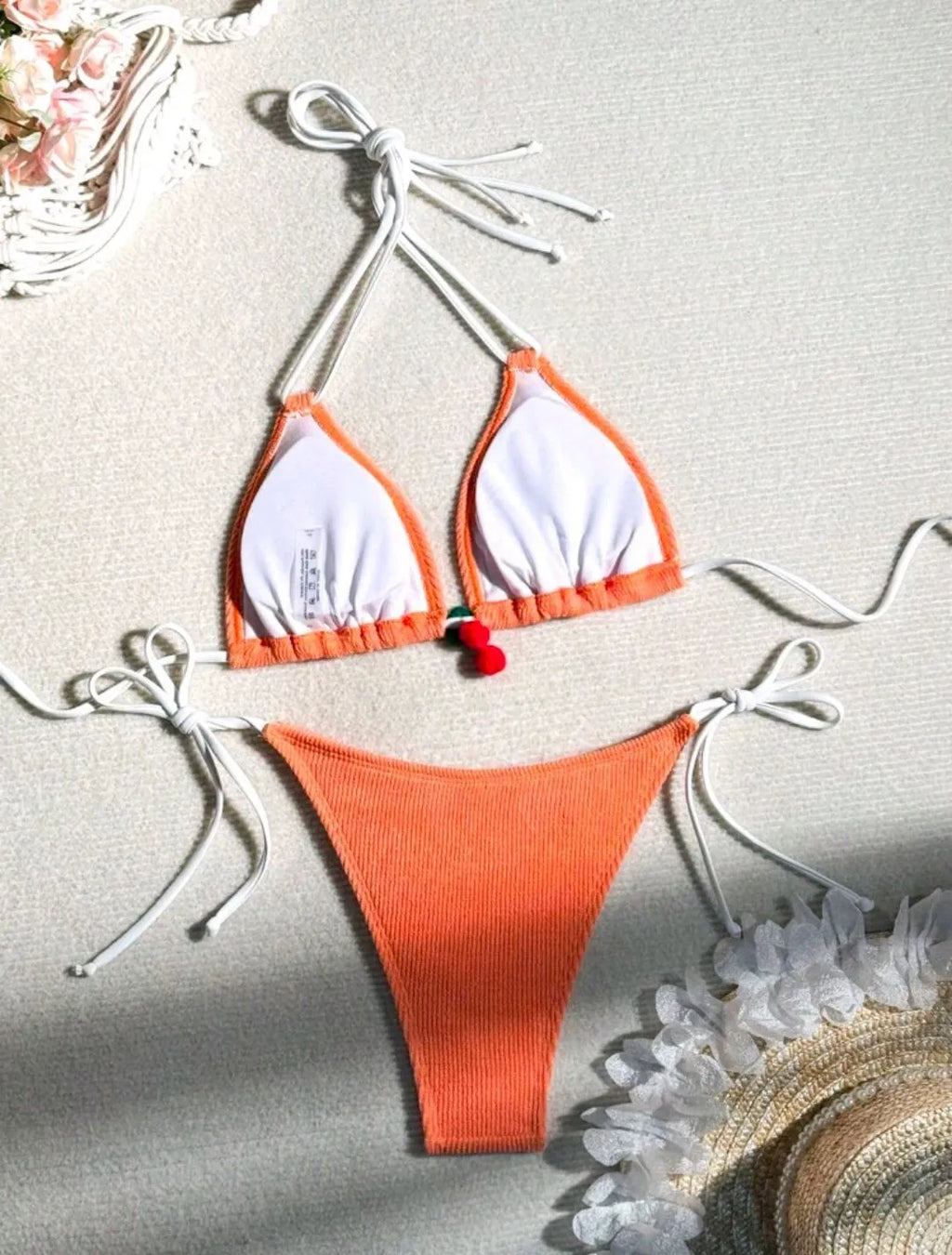 Women's bikini swimsuit set in a briefs style, shown in one of five solid colours: apricot, matcha, orange, pink, or white.