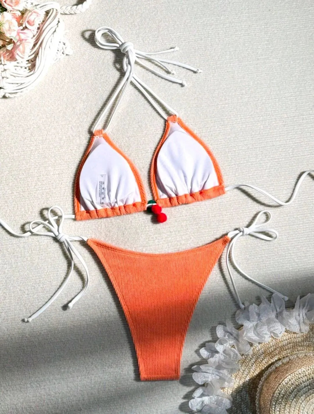 Women's bikini swimsuit set in a briefs style, shown in one of five solid colours: apricot, matcha, orange, pink, or white.